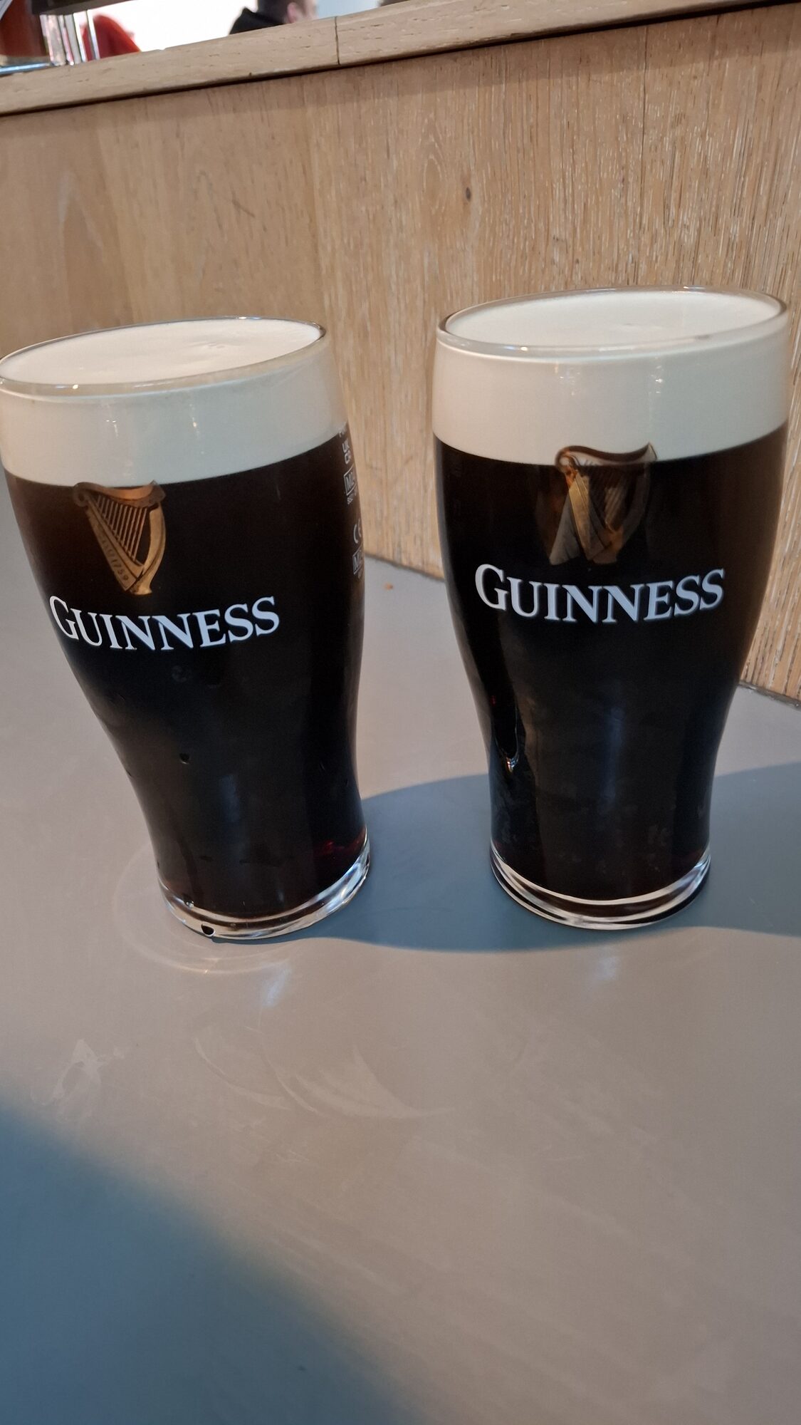 Two pints of Guinness at the bar
