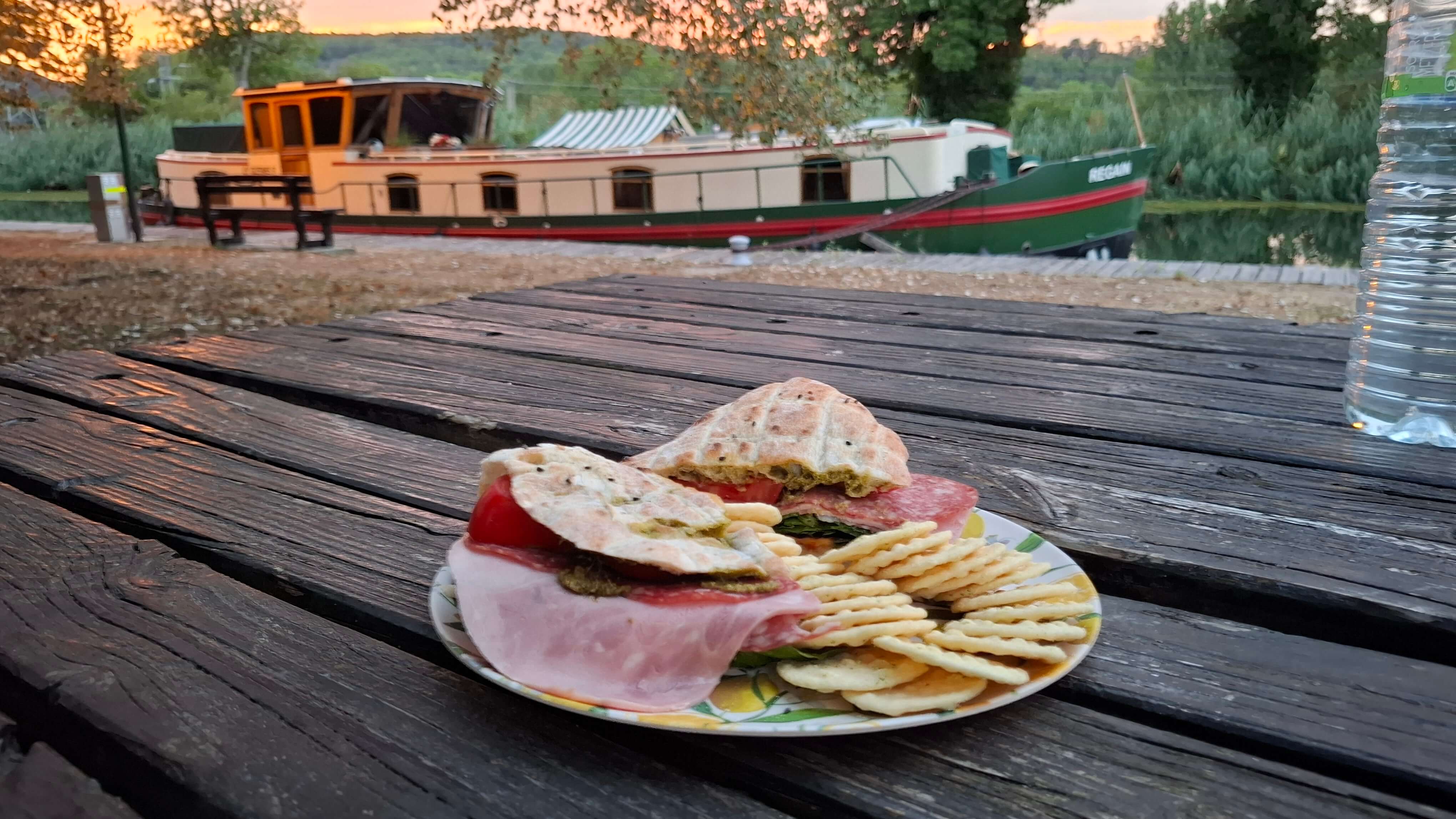 Ham salad bap by the river at sunset