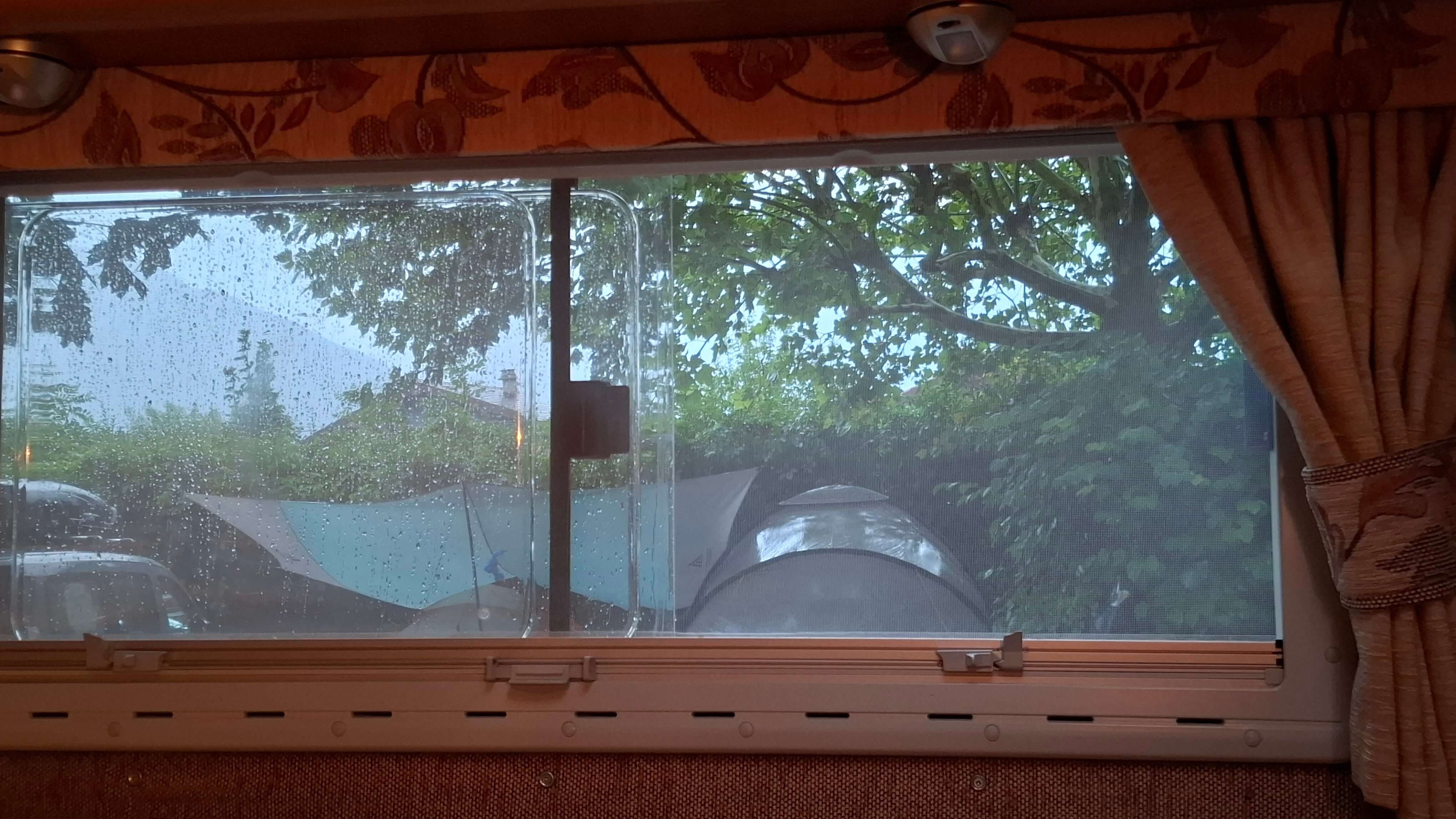 Rain streaking down the van window