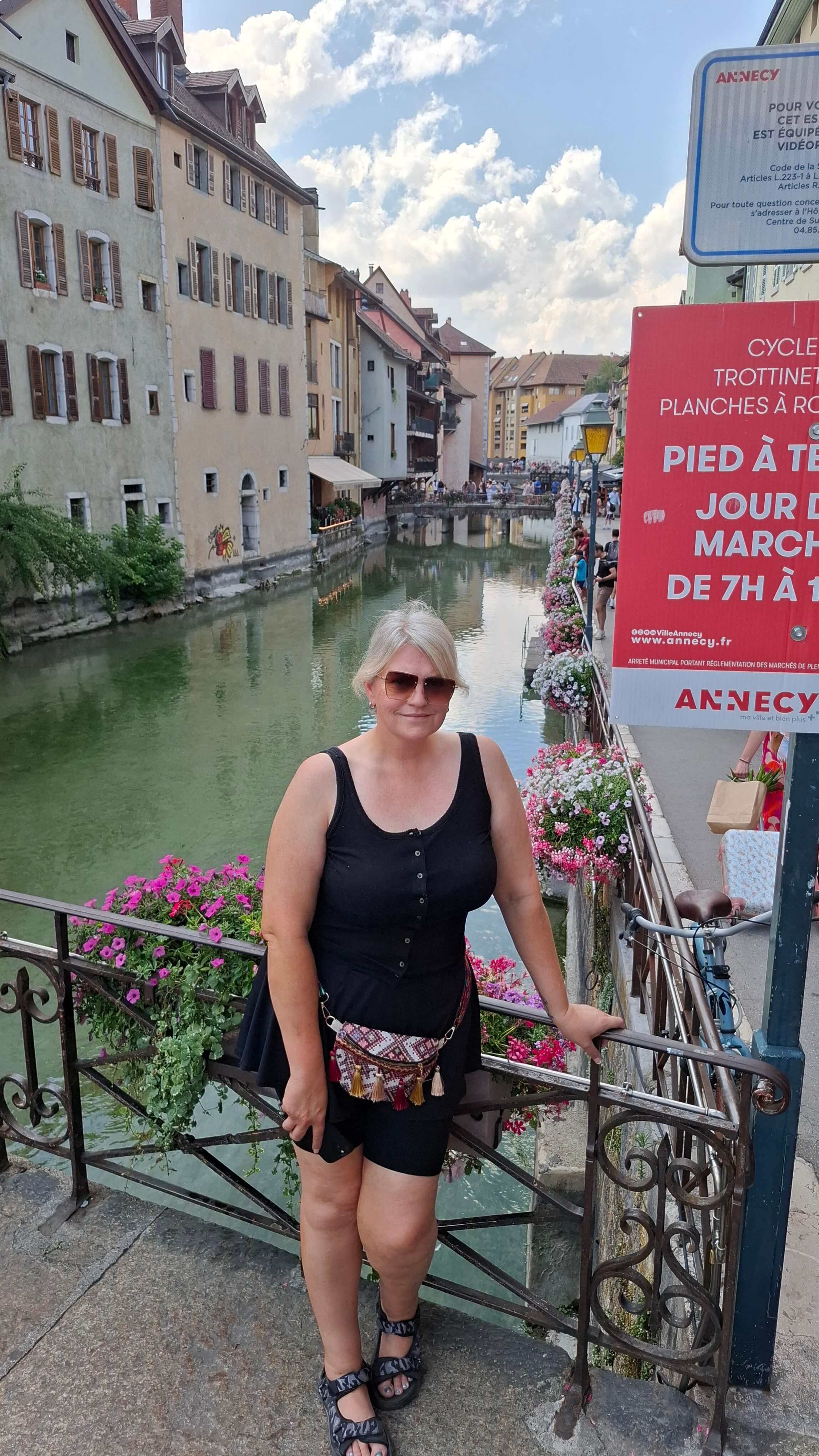 Mel on the bridge with the &ldquo;Annecy&rdquo; sign